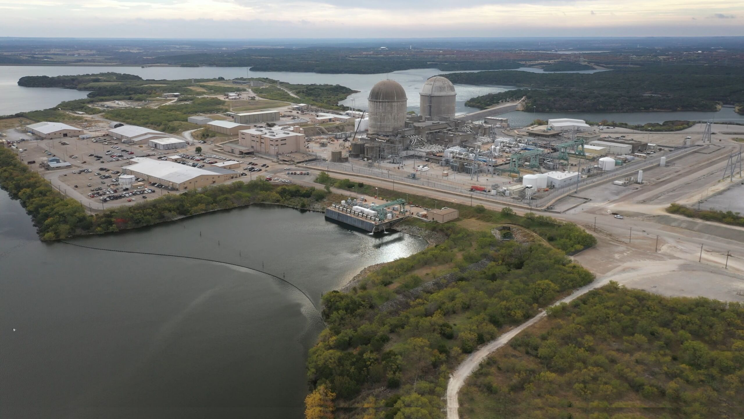 Aerial view of Comanche Peak Nuclear Power Plant in Texas with twin containment domes and surrounding facility infrastructure.