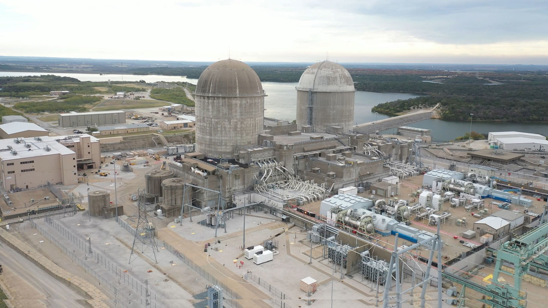 Aerial view of Comanche Peak Nuclear Power Plant in Texas with twin containment domes and surrounding facility infrastructure.